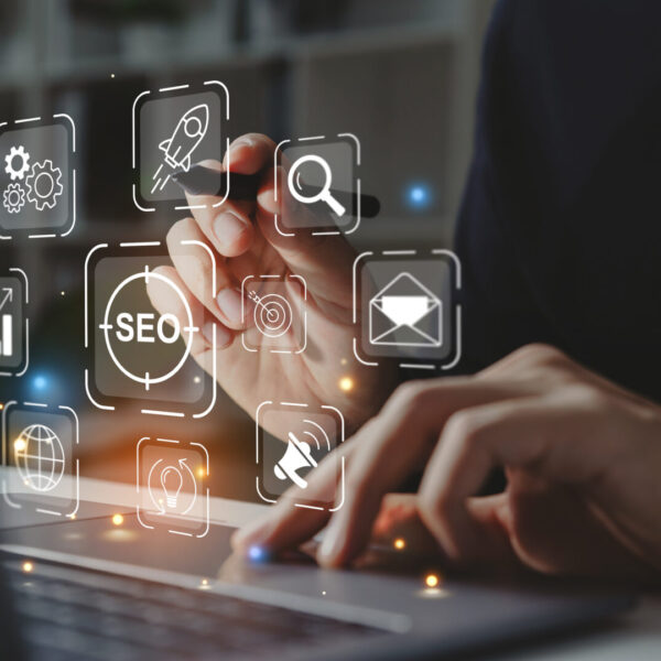 Hand of businessman holding a pen pointing to SEO Search Engine