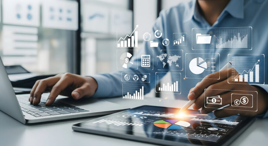 Businessman using laptop computer analyzing data.