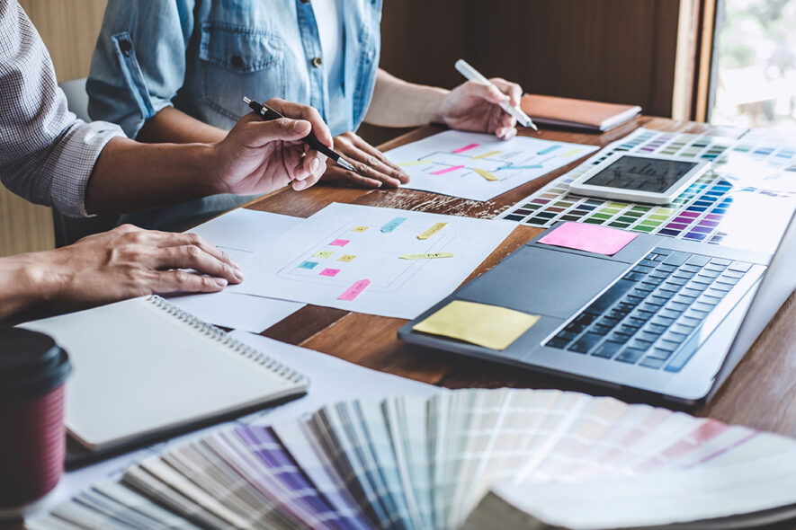 Team of Creative Web/Graphic Designer planning, drawing website