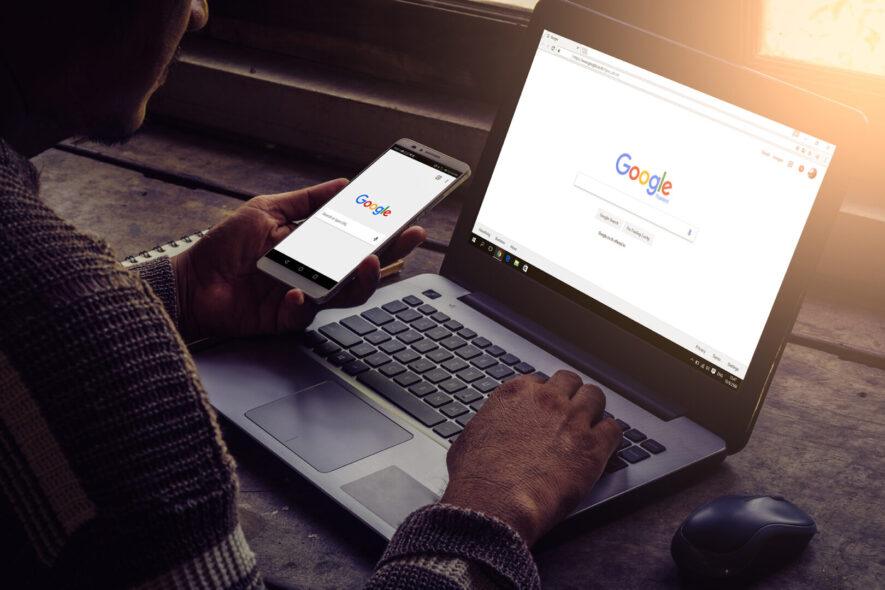 Man is searching Google on his laptop and mobile phone